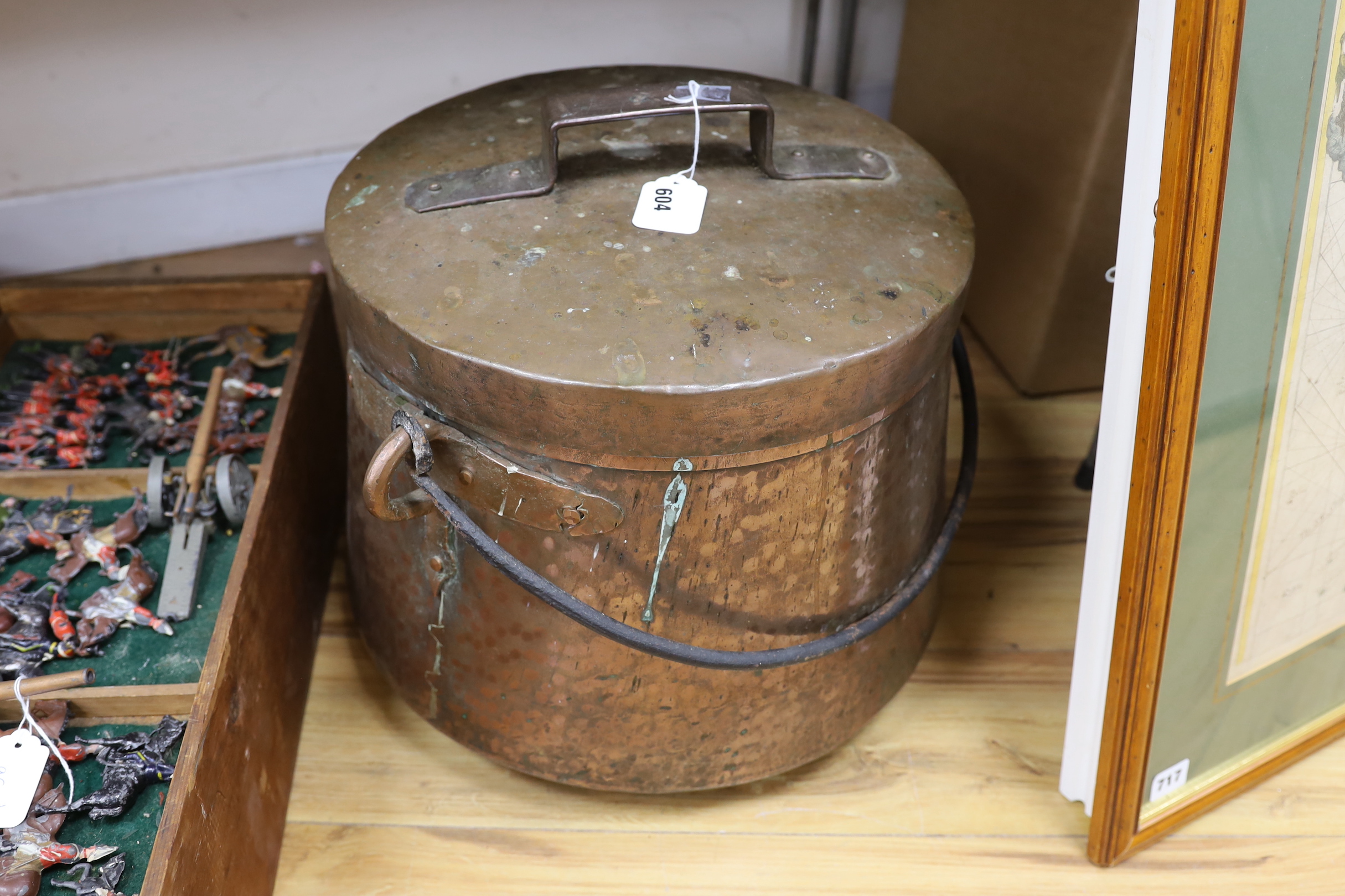 A large hammered copper cauldron and cover, 35cm high not including handle on cover